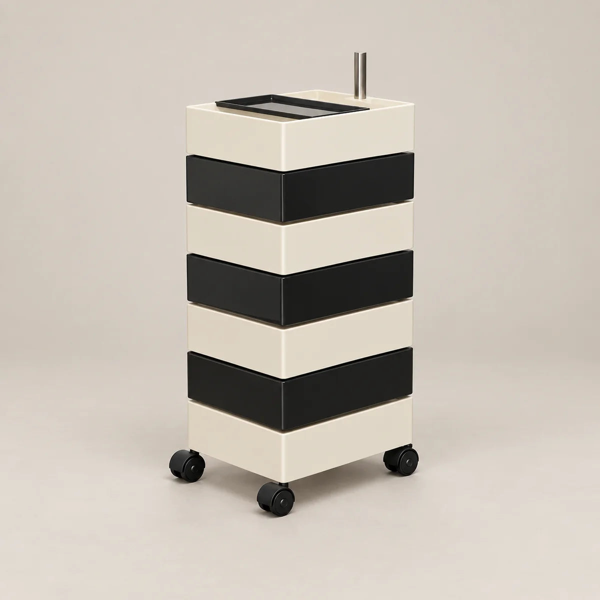 A modern rolling storage cart with four black-and-cream horizontal drawers and black caster wheels, shown on a plain warm light-gray studio background.