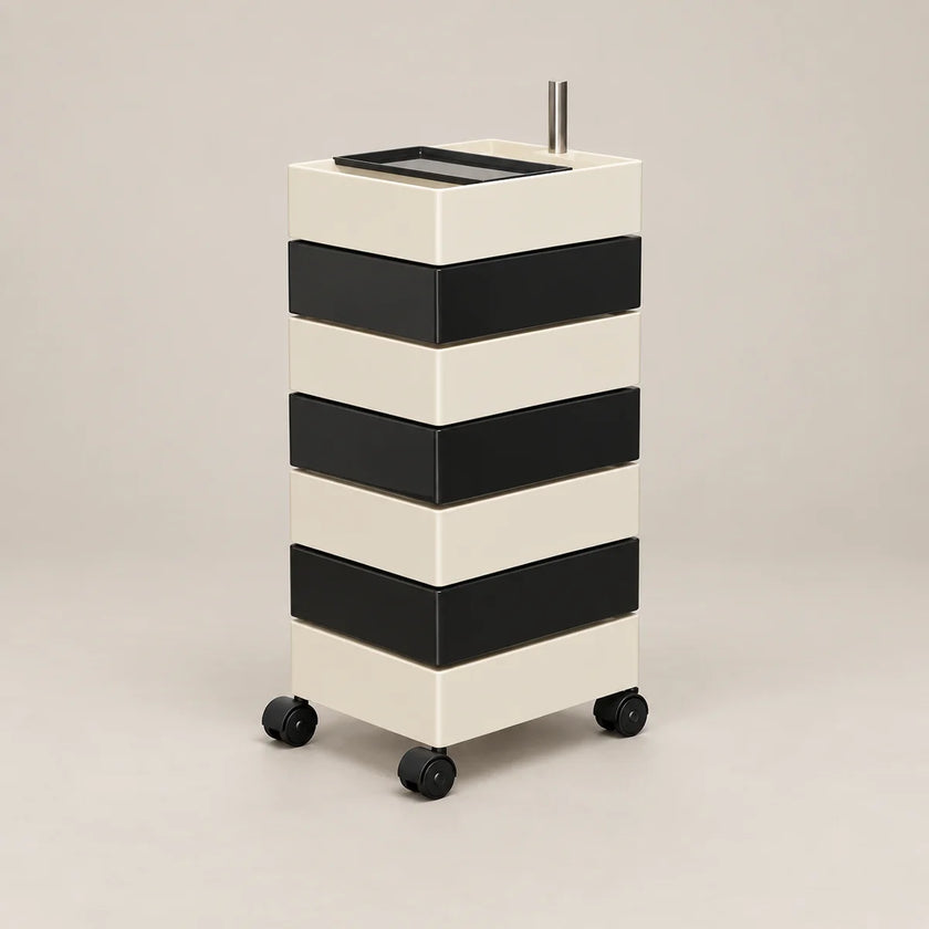 A modern rolling storage cart with four black-and-cream horizontal drawers and black caster wheels, shown on a plain warm light-gray studio background.