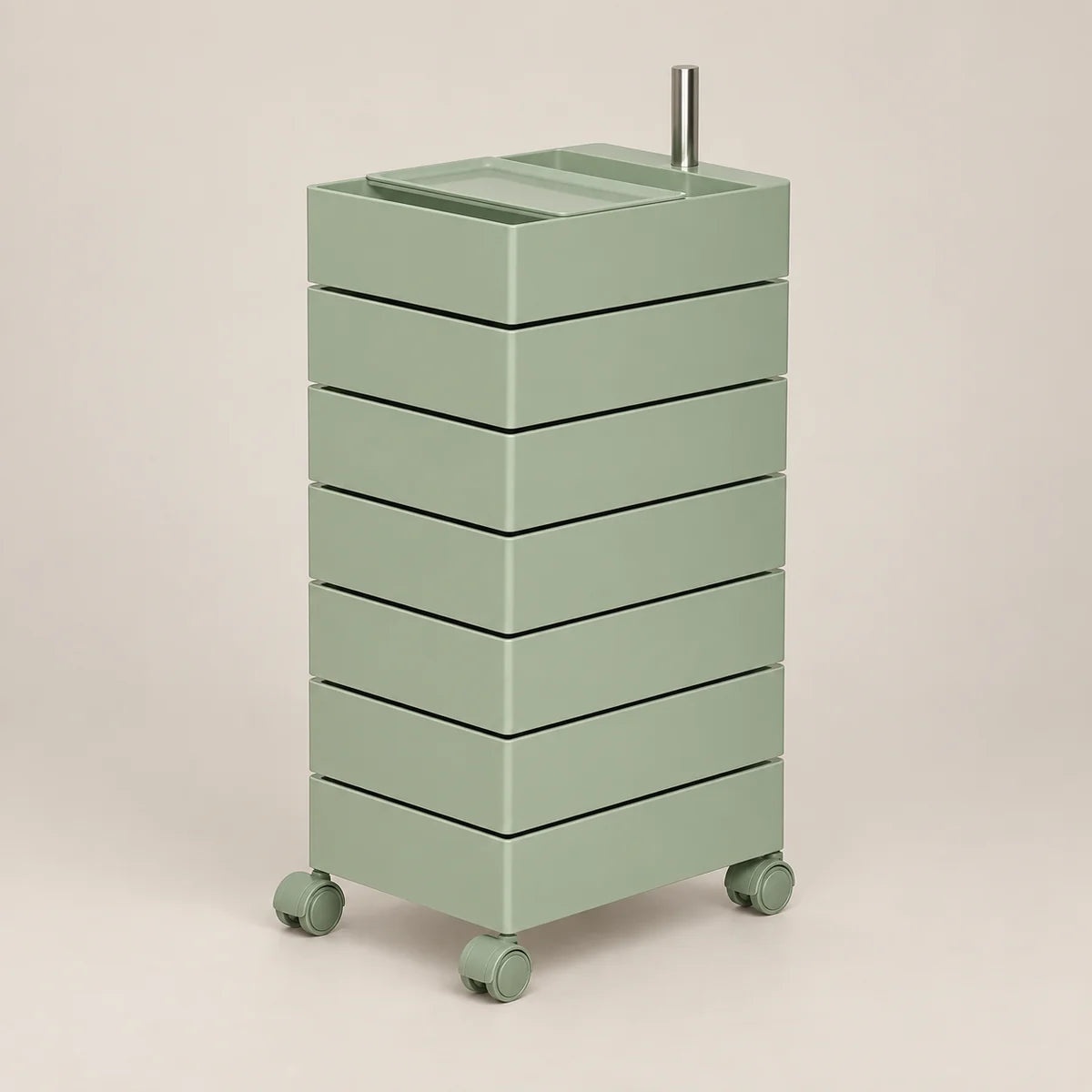 A mint green rolling storage cabinet with six stacked drawers and a metal handle on top, set against a solid beige background.