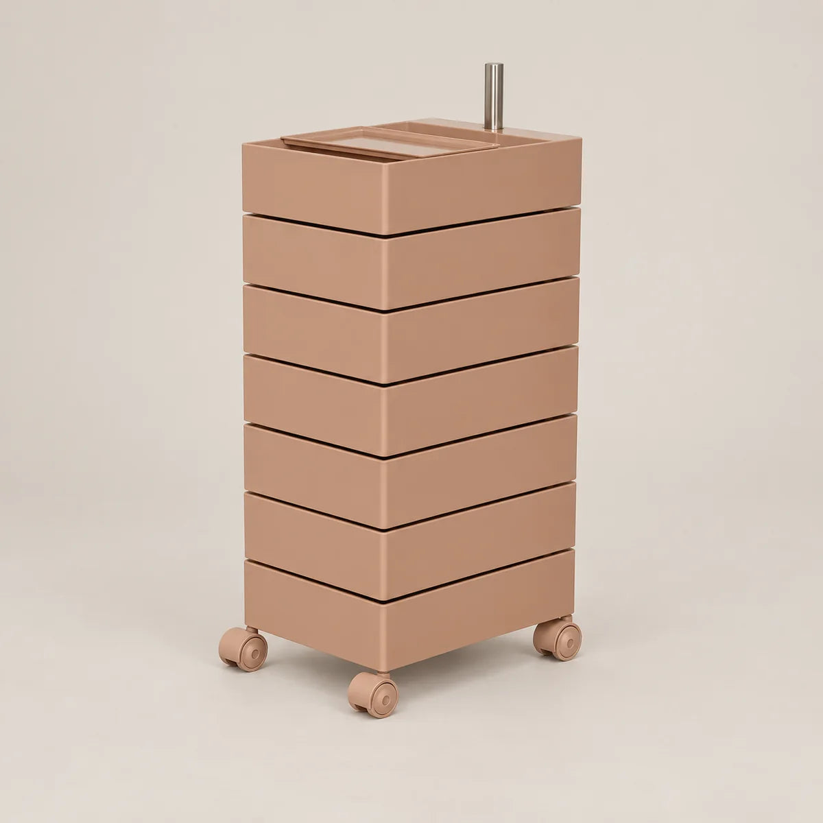 A minimalist, modern rolling storage cabinet with six stacked drawers in a warm taupe-brown color, featuring a matching top tray and small wheels, set against a solid light beige background.
