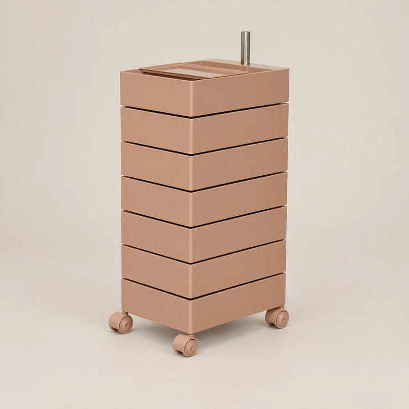 A minimalist, modern rolling storage cabinet with six stacked drawers in a warm taupe-brown color, featuring a matching top tray and small wheels, set against a solid light beige background.