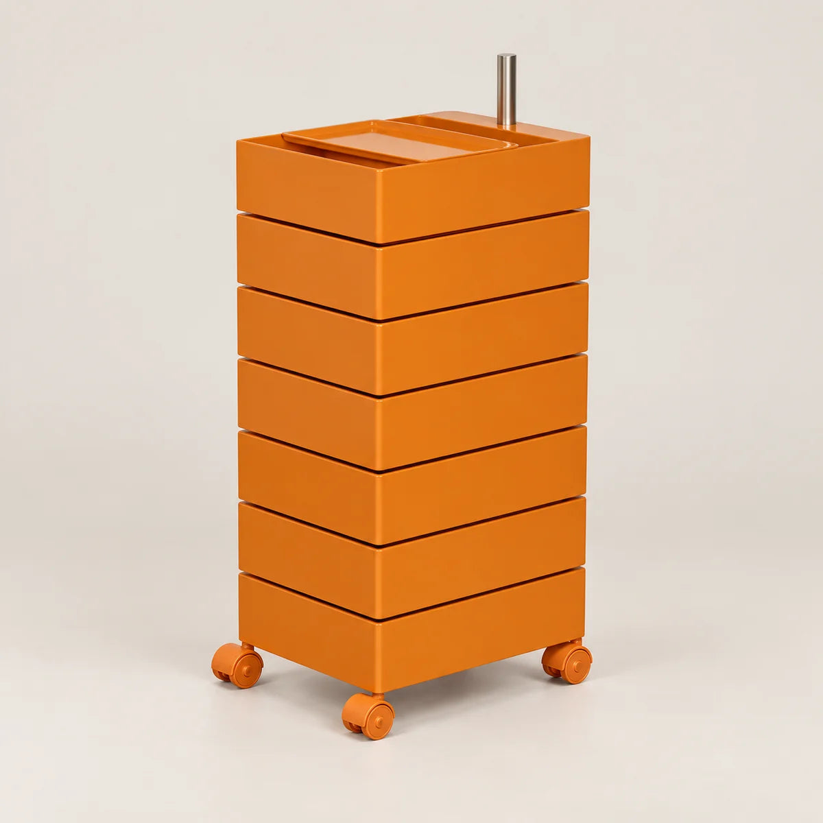 An orange rolling storage cart with six stacked drawers and a metal handle on top, photographed on a clean light gray studio background.