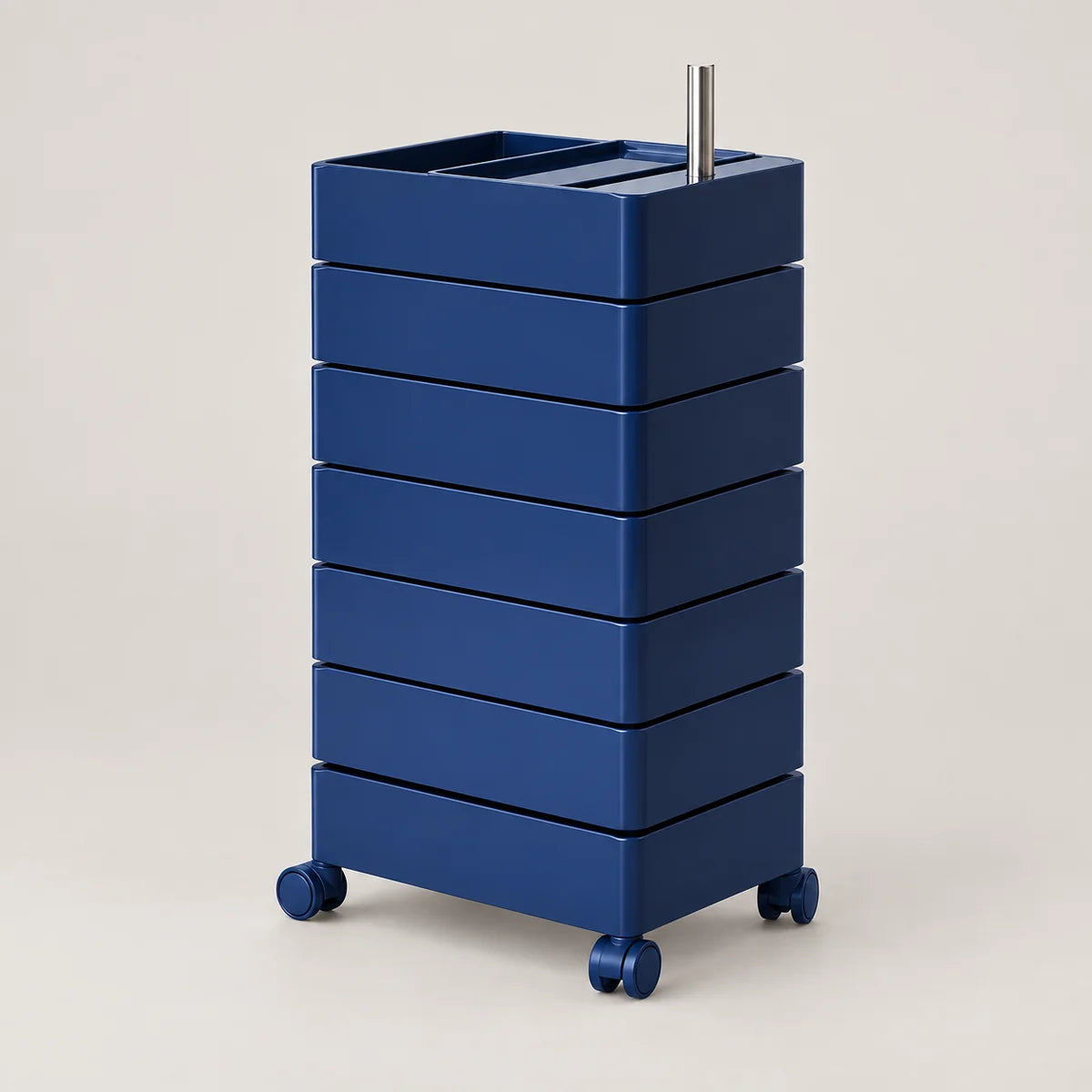 A tall, dark blue rolling storage cart with multiple stacked drawers and a metal handle, photographed on a clean light beige studio background.