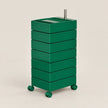 A green rolling storage cart with six stacked drawers and a metal handle on top, shown on a plain beige studio background.