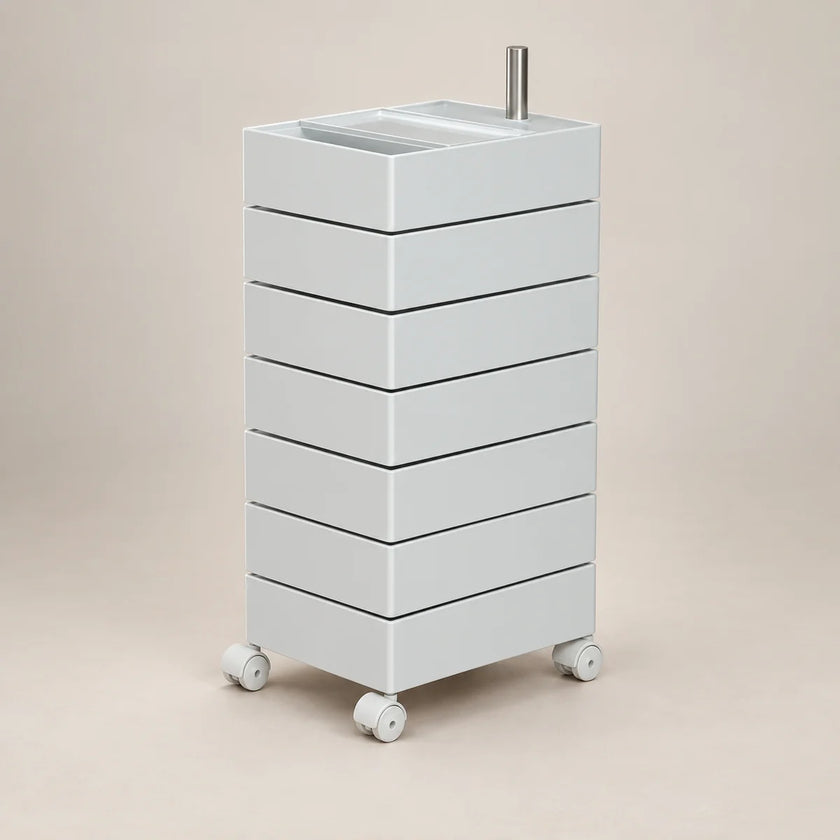A white rolling storage cart with six stacked drawers, a top tray, and caster wheels, shown on a plain beige studio background.