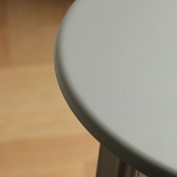 Round gray table top on a blurred brown background