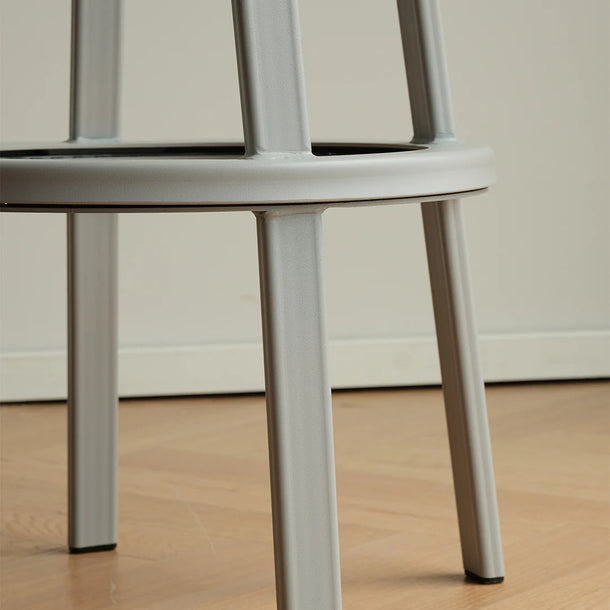 Close-up of a chair with metal legs on a wooden floor.