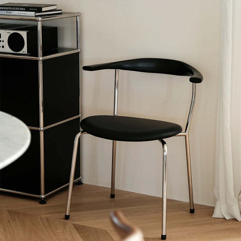 Black chair with metal legs in a room setting