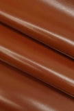 Close-up of brown leather fabric with a smooth texture