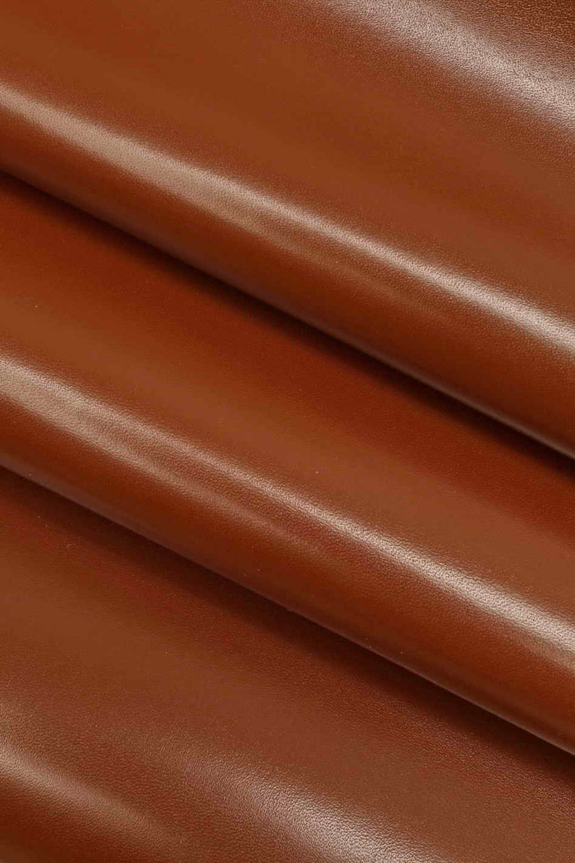 Close-up of brown leather fabric with a smooth texture