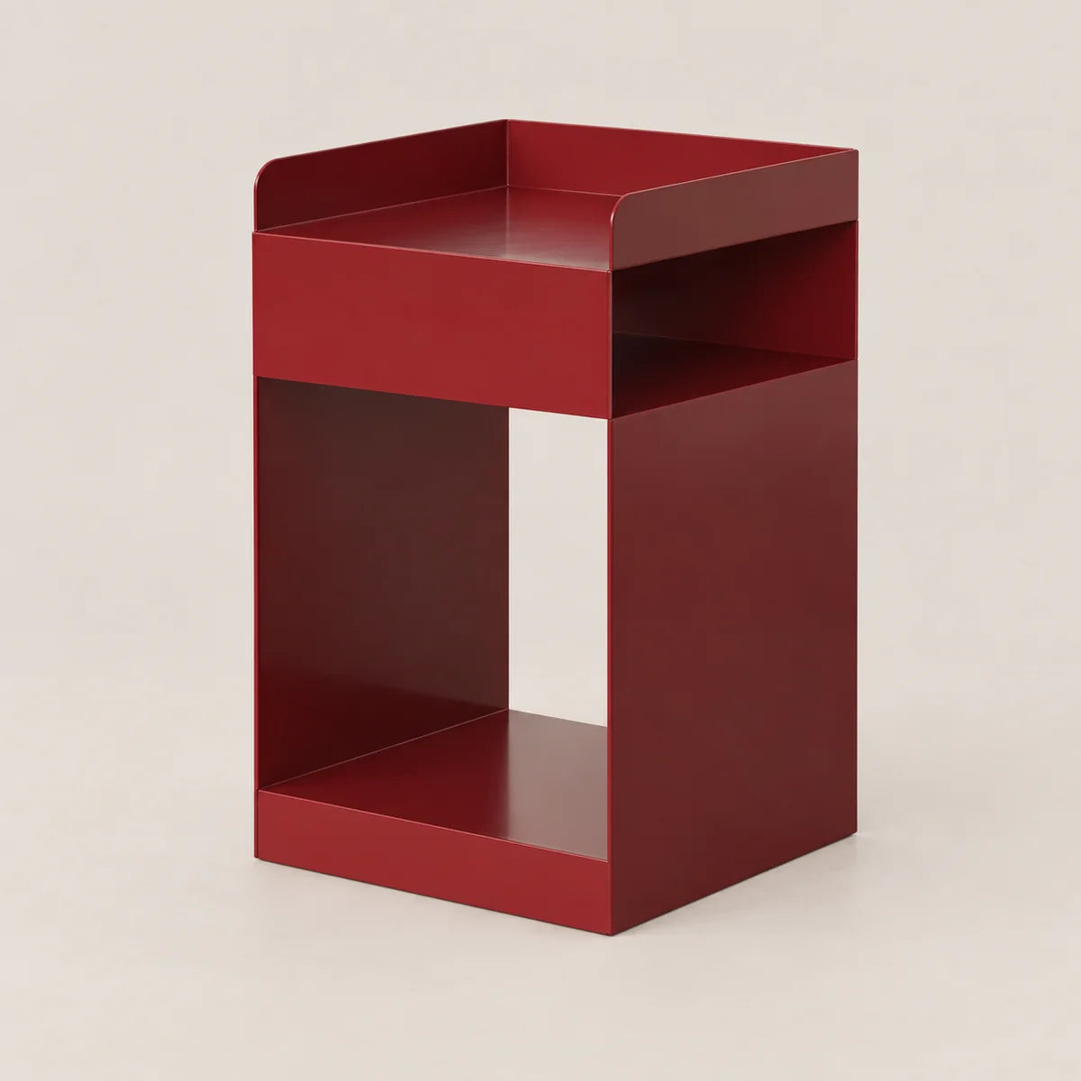 A modern, minimalist red metal side table with a geometric open design, photographed on a neutral light beige background.