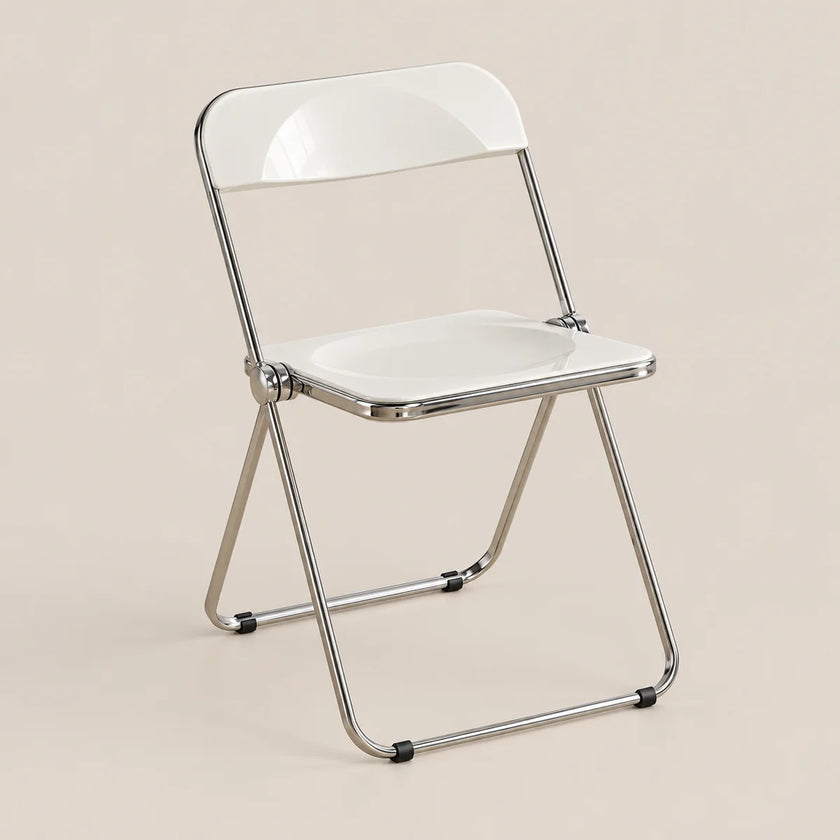 A modern folding chair with a glossy white seat and backrest, supported by a slim metallic silver frame, set against a solid light beige background.