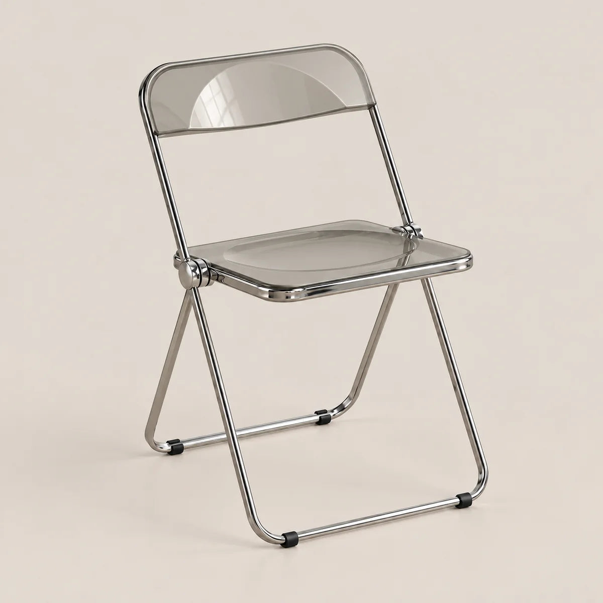 A modern folding chair with a transparent smoky-gray seat and backrest, supported by a polished silver metal frame, set against a solid light beige background.