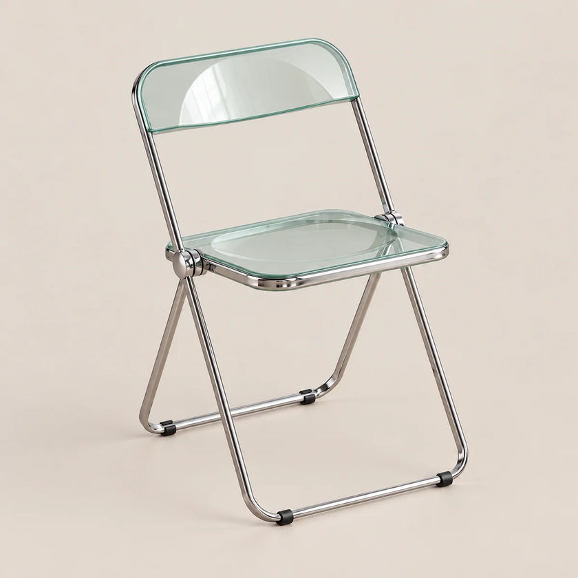 A folding chair with a clear glass seat and backrest on a chrome metal frame, set against a solid beige background.
