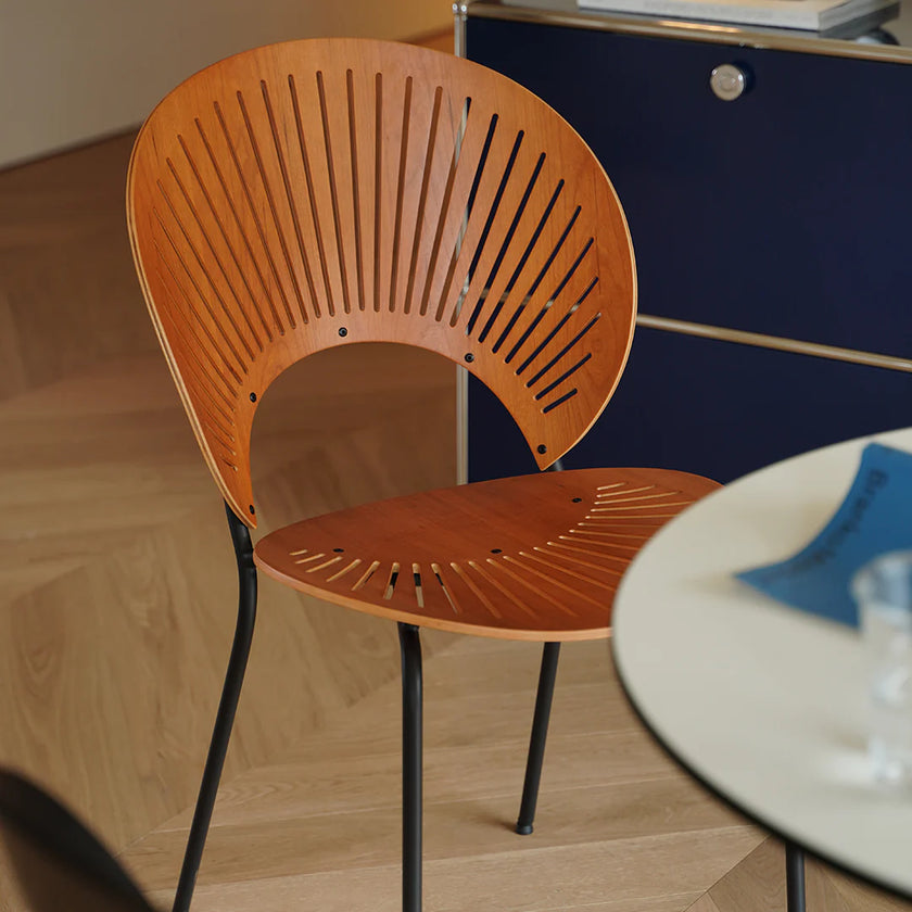 Wooden chair with black legs on a wooden floor