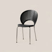 A modern black plastic dining chair with a slatted backrest and slim metal legs, shown against a solid light beige background.