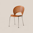 A modern side chair with a curved, slatted backrest and seat upholstered in warm tan leather, supported by slim chrome metal legs, set against a solid light beige background.