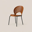 A modern slatted wooden dining chair with a warm brown seat and backrest, supported by slim black metal legs, shown against a solid light beige background.