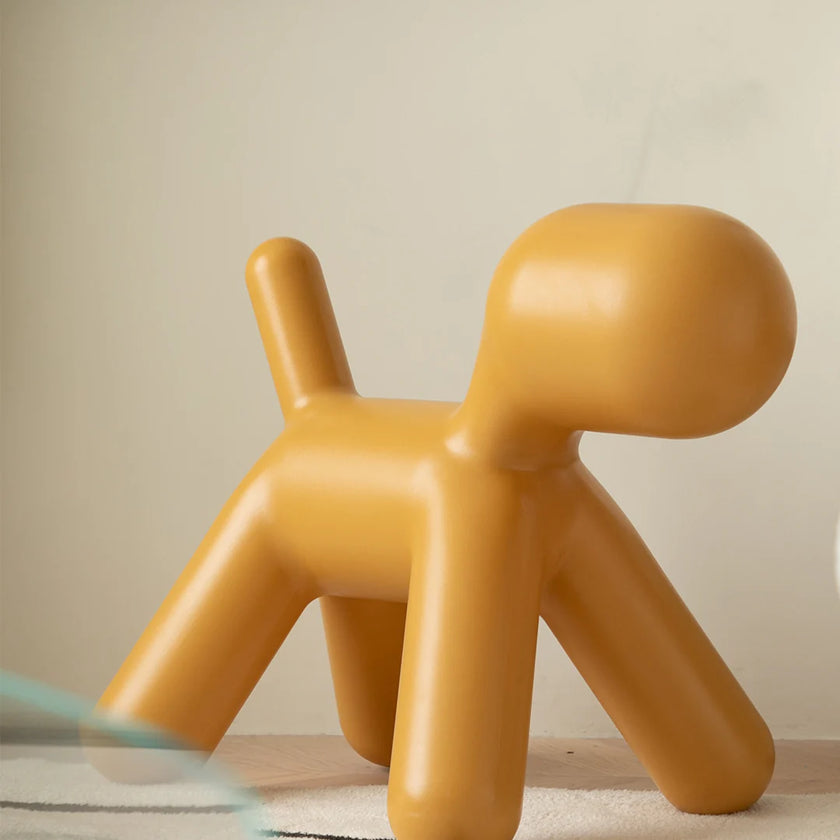 Yellow dog-shaped chair on a neutral background