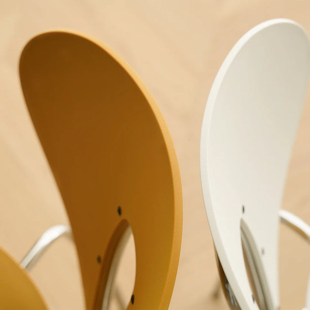 Close-up of a brown and white chair on a beige background