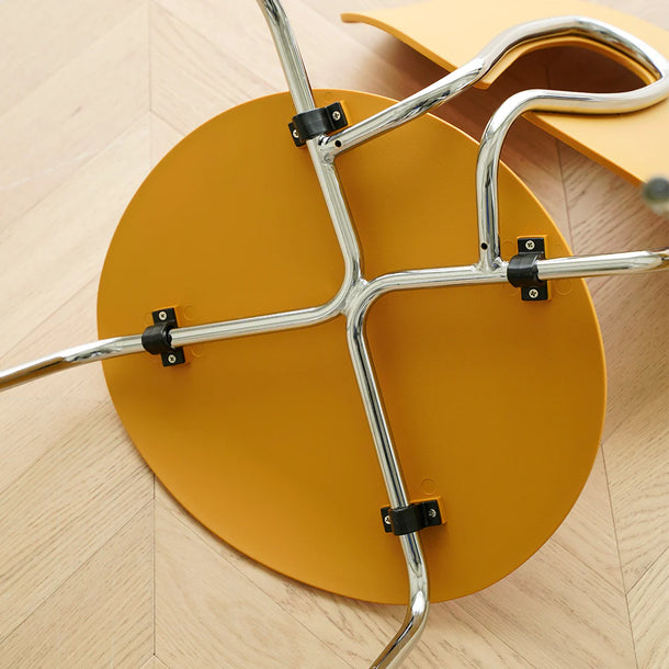 Close-up of a chair's metal base on a wooden floor