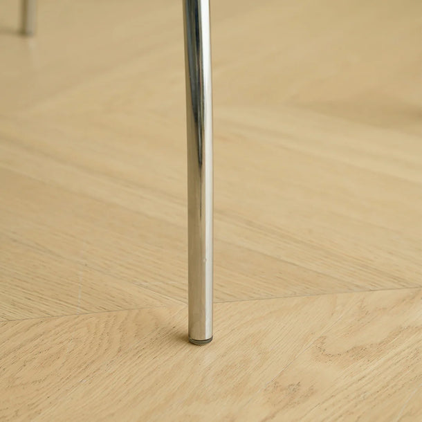 Close-up of a metal leg on a wooden floor