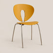 A modern side chair with a curved mustard yellow plastic shell and slim silver metal legs, shown against a solid light beige background.