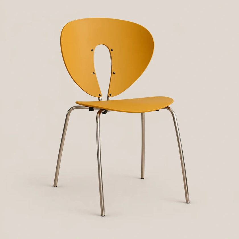 A modern side chair with a curved mustard yellow plastic shell and slim silver metal legs, shown against a solid light beige background.