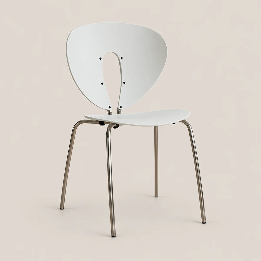 A modern white molded chair with a curved backrest and slim metallic legs, shown against a solid light beige background.