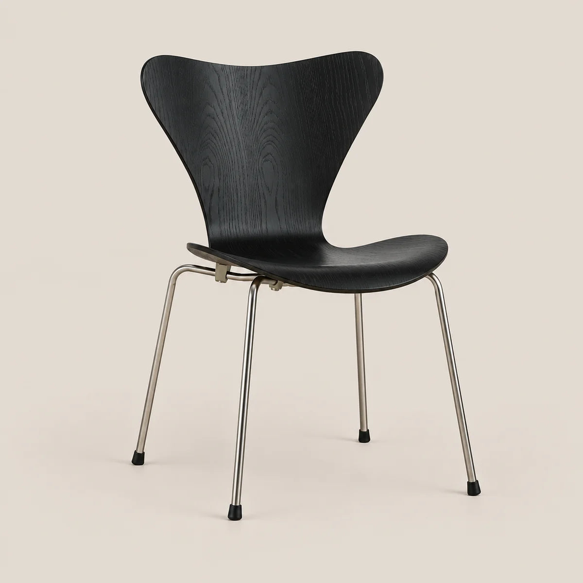 A modern black chair with a curved wooden shell seat and slim metal legs, shown against a solid light beige background.