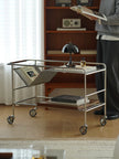 Metal serving cart with books and a lamp in a room setting