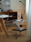 Bar cart with wine bottle and glasses in a room setting