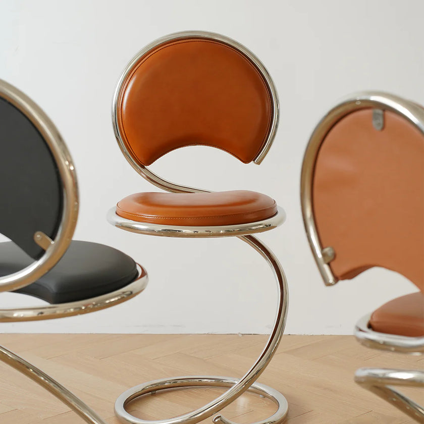Modern chairs with brown leather seats and metal frames on a wooden floor.