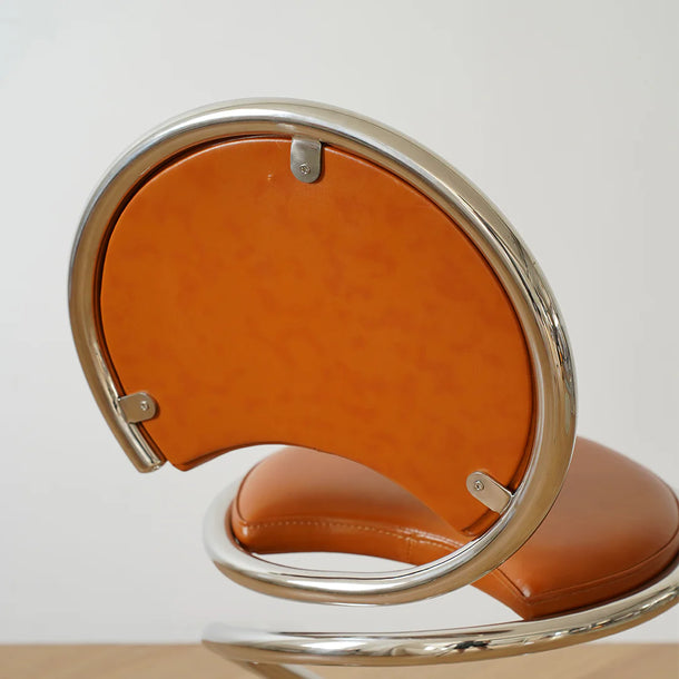 Modern chair with orange seat and backrest on a white background