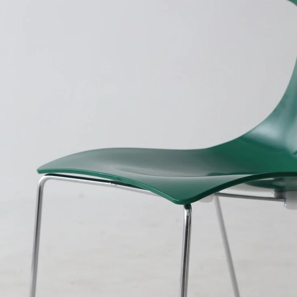 Green chair with metal legs on a light gray background