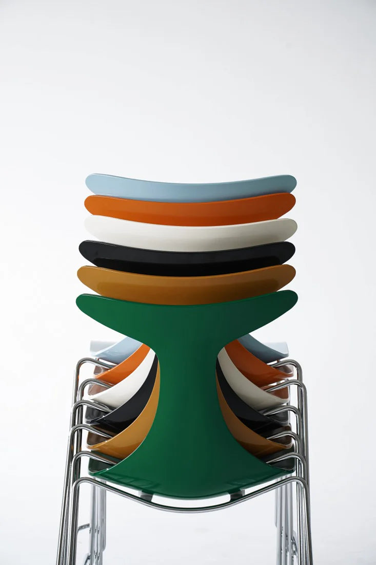 Stack of colorful chairs with a green base on a white background