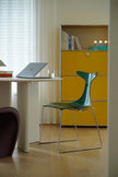 Modern office setup with a green chair, white table, and yellow storage unit.