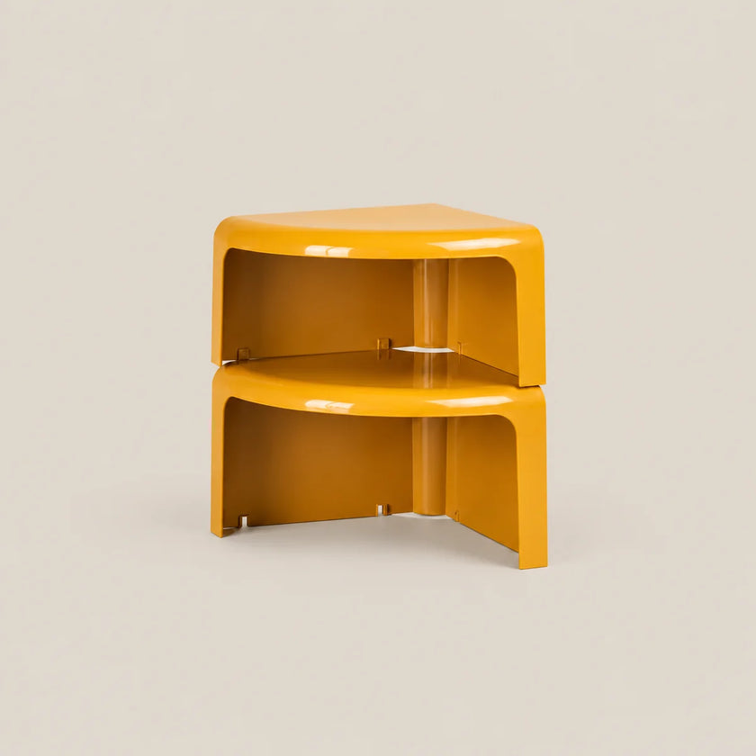 A pair of matching mustard yellow corner side tables stacked vertically, shown on a neutral light beige background.