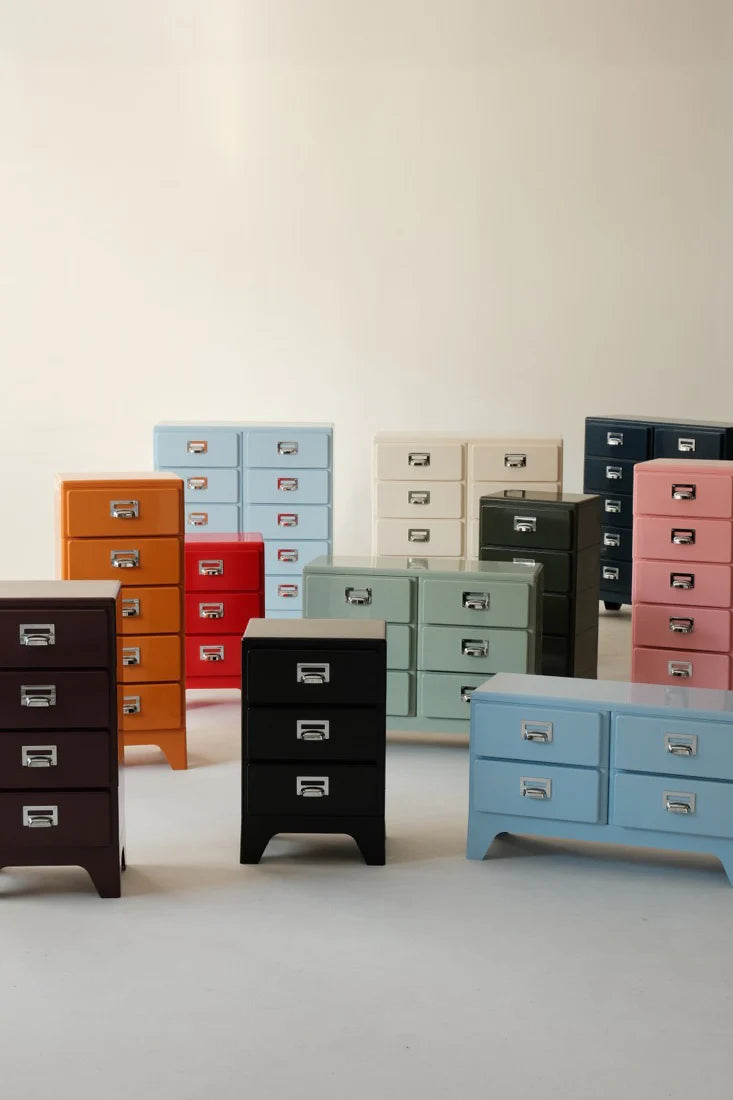 Collection of colorful metal drawers on a light background