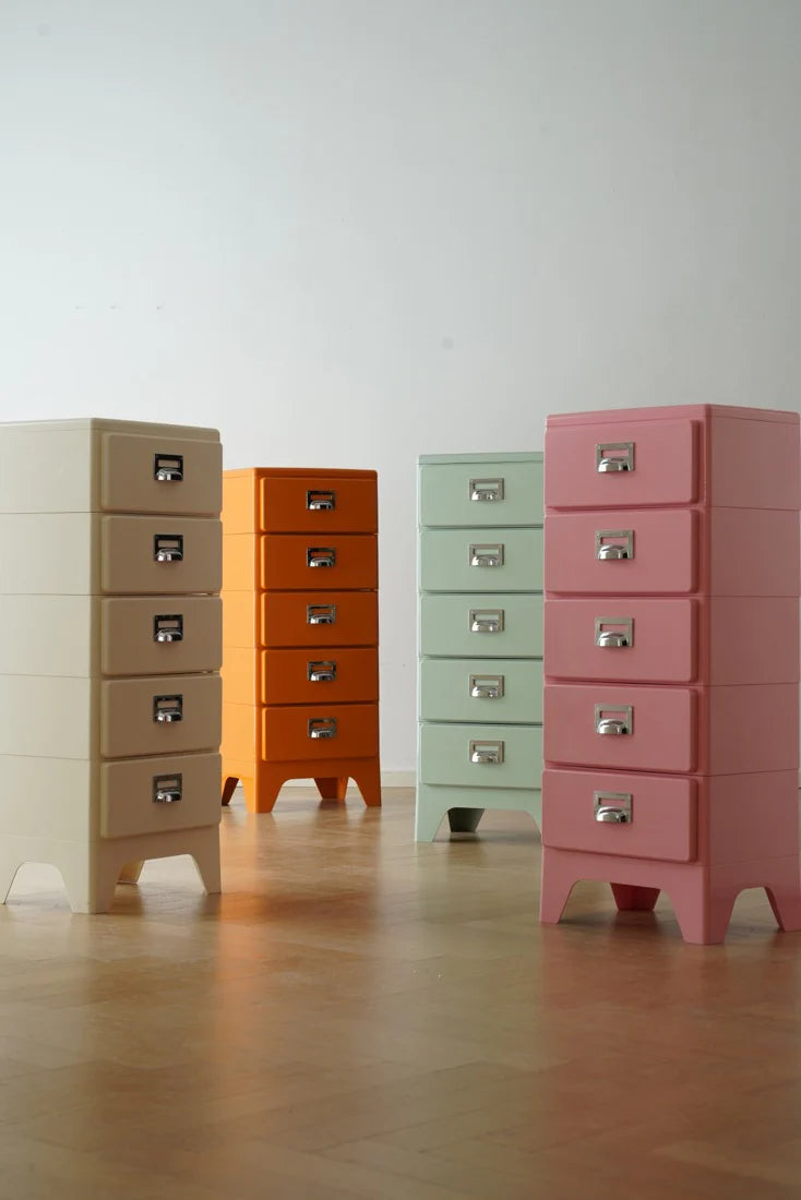Four colorful filing cabinets of different sizes on a wooden floor.