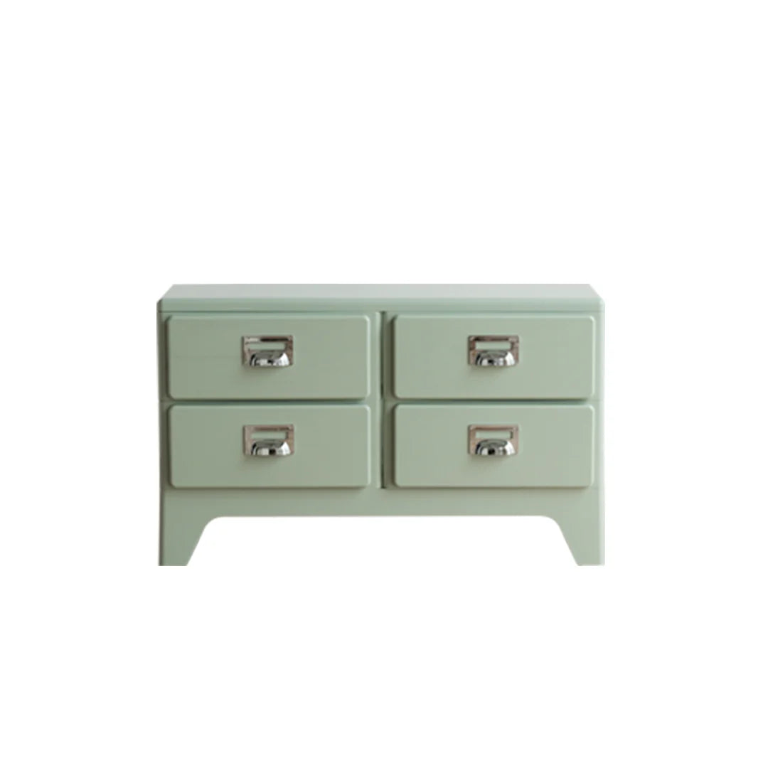 Light green dresser with four drawers on a white background