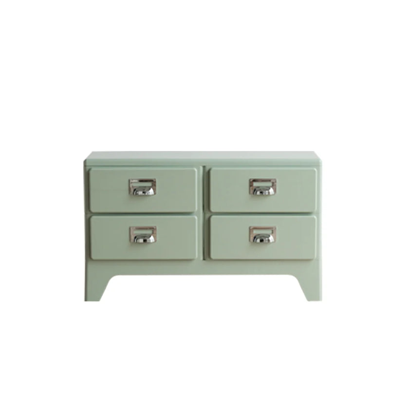 Light green dresser with four drawers on a white background