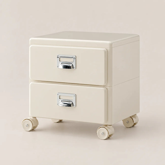 An off-white two-drawer rolling storage cabinet with silver metal drawer pulls, set against a solid light beige background.