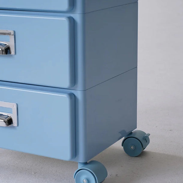 Blue abs filing cabinet with wheels on a gray floor.