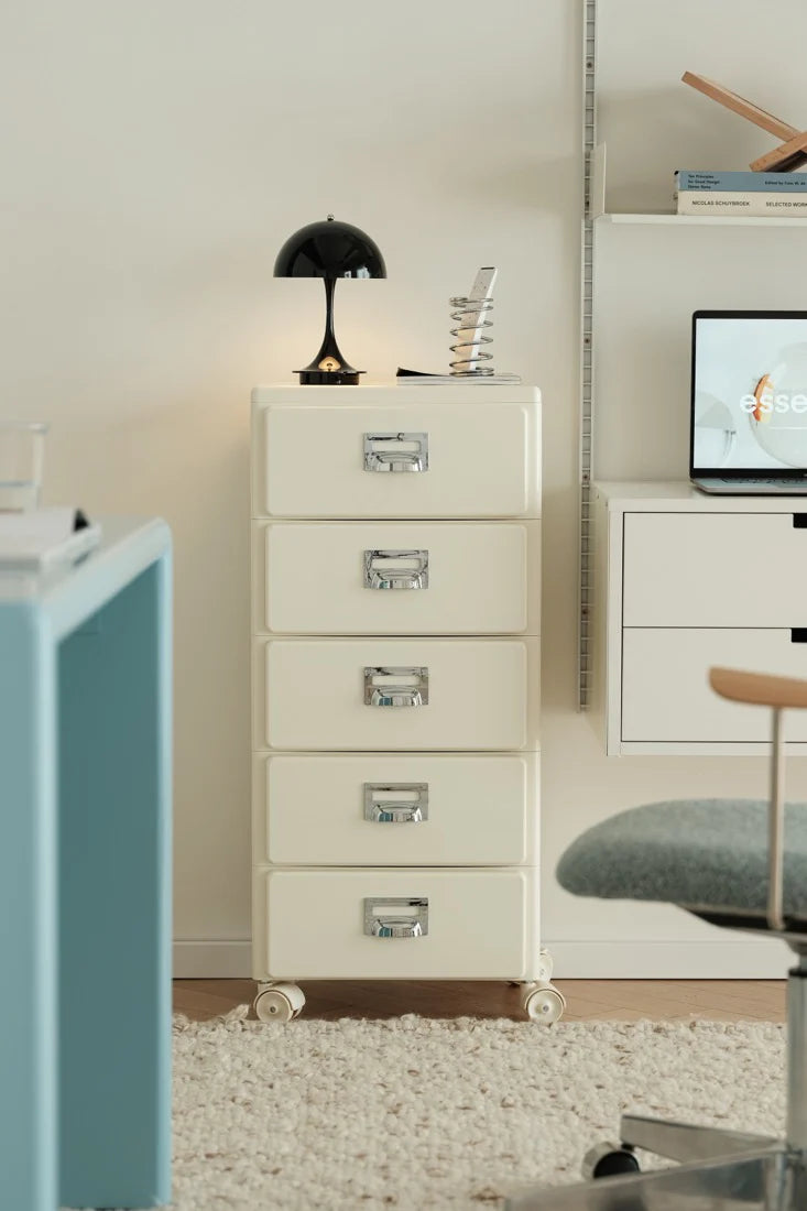 White filing cabinet in a room with a desk and chair.
