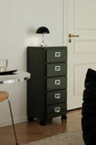 Green abs file cabinet with four drawers in a room setting.