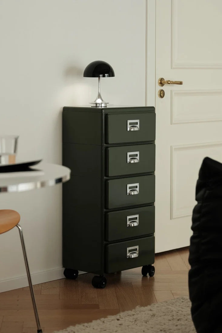 Green abs file cabinet with four drawers in a room setting.