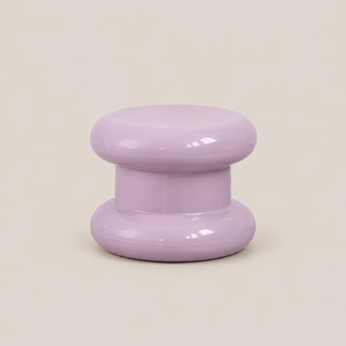 A glossy lavender purple mushroom-shaped decorative object, likely a candle holder or small stool, centered on a solid light beige background.