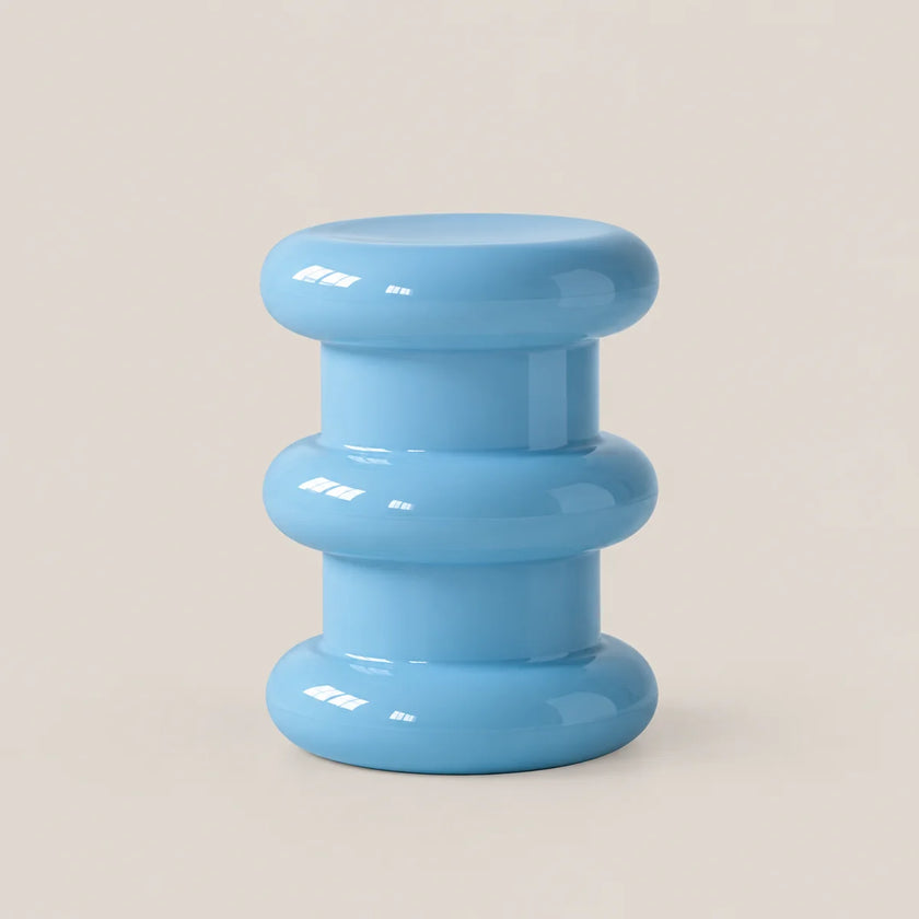A light blue modern tiered stool with a glossy finish, set against a solid beige background.