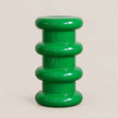 A glossy green sculptural side stool with a stacked, rounded organic design on a light beige background.